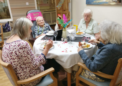 Residents enjoying a movie themed birthday party at Lulworth House Residential Care Home together