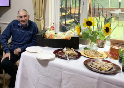 Lulworth House resident sitting by a harvest themed table