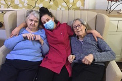 Lulworth House Residential Care Home staff member with two residents