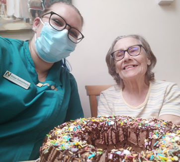 Lulworth House Residential Care Home resident and staff member with a decorated chocolate cake hey have made