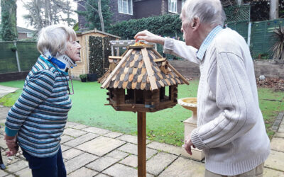 Stocking up the bird food outside at Lulworth House Residential Care Home