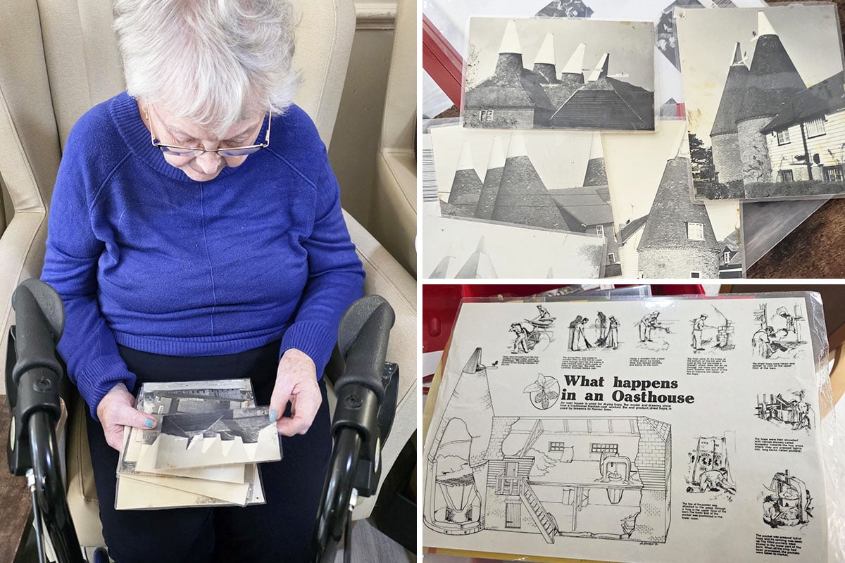Residents at Lulworth House taking part in a reminiscence session using photographs, postcards and books from the 1950s hop farm.